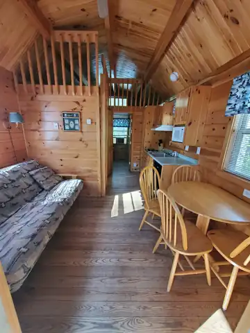 Interior of Deluxe Cabin featuring cathedral ceilings, a loft, and kitchenette
